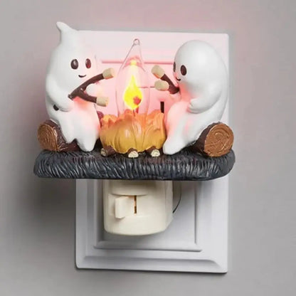 Halloween ghost campfire lamp showing resin ghost figures around an orange LED flame